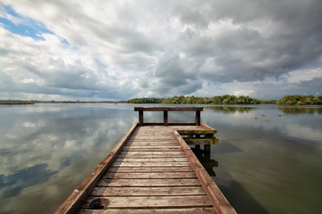 Fototapeta na wymiar wooden pier on big lake during sunny day