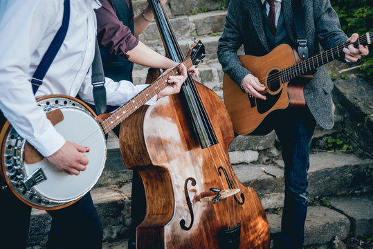 Trio of musicians with a guitar, banjo and contrabass