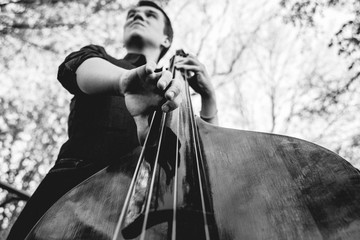 View of musician playing contrabass at the street. Musical Instrument