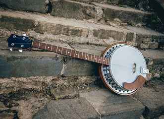 Silver metalic banjo on the stone stairs