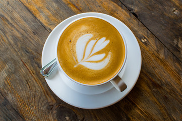 cappuccino cup on the brown wooden table