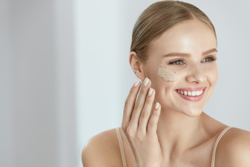 Face Skin Scrub. Smiling Female Applying Scrub On Face Skin