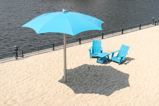 Clock Tower Beach Old Port In Montreal Canada Two Blue Chairs With Parasol