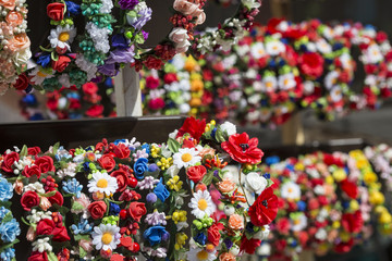 Colorful traditional flower wreath on sale on local market.