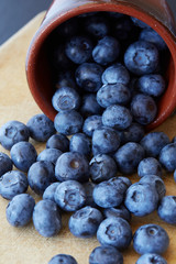 Blueberry on wooden background. Ripe and juicy fresh picked blueberries closeup