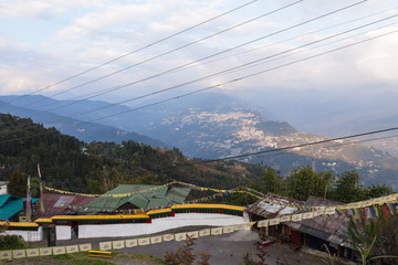 Gangtok mountain village with green trees, blue sky and wire that view form upper level of Rumtek Monastery in winter near Gangtok. Sikkim, India.