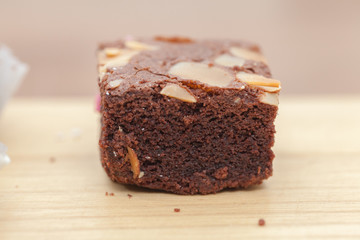 close up of of brownie cake on wooden plate
