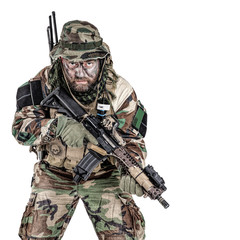 Special forces United States in Camouflage Uniforms studio shot. Holding weapons, wearing jungle hat, Shemagh scarf, painted face, his outfit clothes designed for jungle warfare. Studio shot isolated