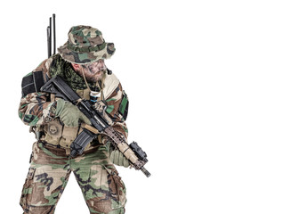 Fototapeta premium Special forces United States in Camouflage Uniforms studio shot. Holding weapons, wearing jungle hat, Shemagh scarf, painted face, his outfit clothes designed for jungle warfare. Studio shot isolated