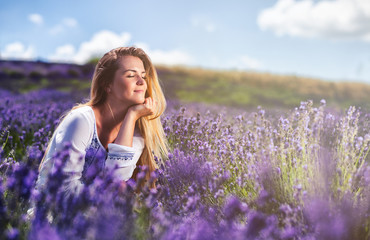 Lovely cute woman in lavender field at sunny day freedom concept