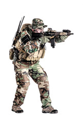Special forces United States in Camouflage Uniforms studio shot. Holding weapons, wearing jungle hat, shooting on the move, attacking enemy. Studio shot isolated