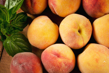 Fototapeta na wymiar Sweet summer peaches and basil, top view