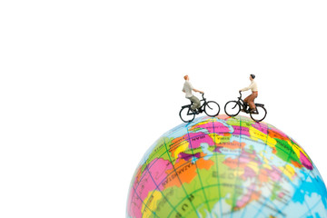 Miniature people travelers with bicycle on The globe