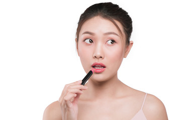 Beautiful young asian woman applying pink lipstick