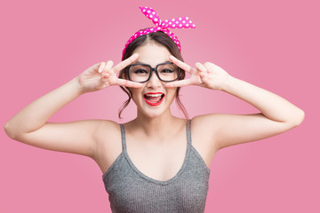 Young cool woman on pink wall background