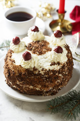 Chocolate and whipped cream cake with cherries