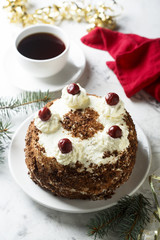 Chocolate and whipped cream cake with cherries