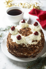 Chocolate and whipped cream cake with cherries