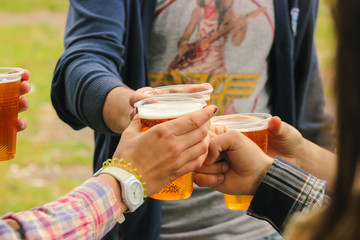 Golden beer, ale or lager in a plastic disposable cup