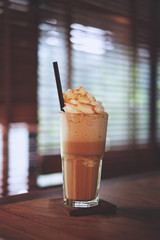 soft focus Ice caramel macchiato coffee in the coffee shop