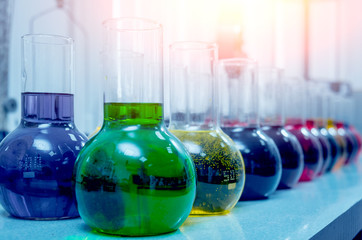Laboratory glassware with colored liquid.