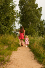 Young mother with baby daughter portrait, a walk in the Park