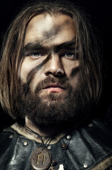 Formidable viking in armor on black background