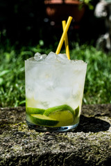 Caipirinha Cocktail with lime and ice.