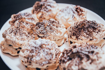 French meringue cookies on the white plate.