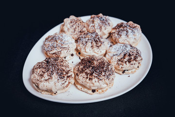 French meringue cookies on the white plate.