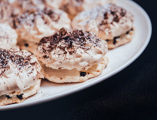 French meringue cookies on the white plate.