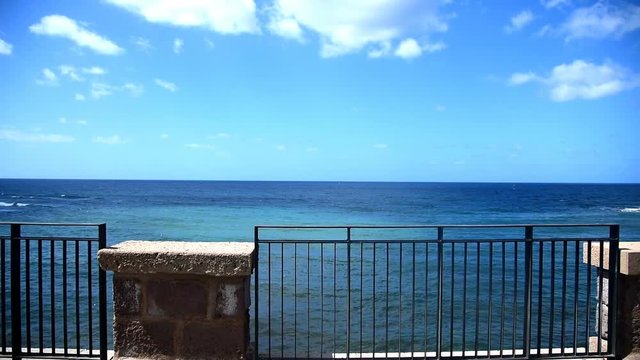 Metal railing by the sea in Alghero seafront. Sardinia, Italy