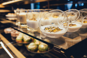Sweets and cakes in showcase. Italian pastry shop. Cakes with fruits, berries and chokolate
