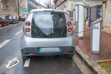 Fototapeta na wymiar Modern car with eco friendly electric engine at charging station
