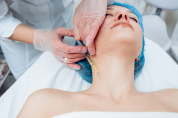 Beautician and the patient in the clinic of aesthetic medicine.