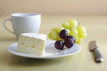 Cheese with grape on a table