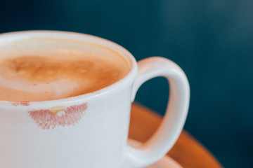 pink lipstick on a latte mug in a cafe