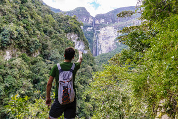 Young tourist pointing with finger on the Gocta waterfallGocta Watterfall/ Chachapoyas/ Peru/ south...