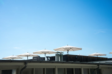 Obraz premium white umbrella in summer sun