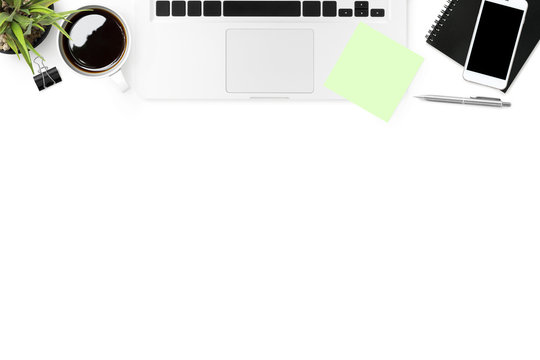 Laptop and supplies isolated on white. Top view with copy space, flat lay.