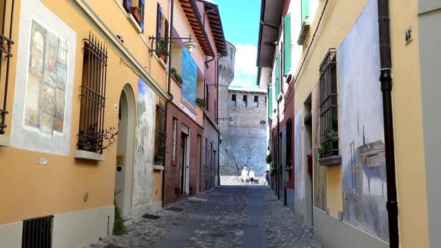 walking in the colorful street of the medieval village of Dozza, a small gem among the architectural wonders of Italy, color graded clip