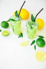 Transparent refreshing cucumber drink with limes and lemons
