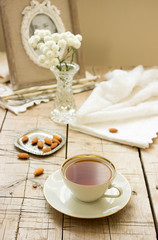 A cup of tea and almonds, breakfast. Style ryustik, selective focus.