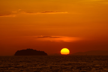 Nature landscape. Sunset or sunrise, sea, island and vibrant sky.