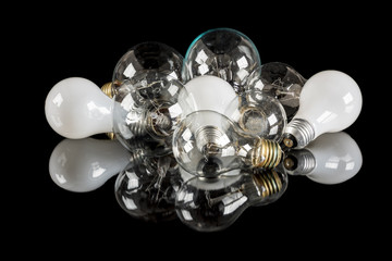 Many incandescent light bulbs of different types on a table
