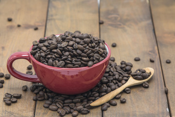 coffee beans in a coffee cup on a wooden floor