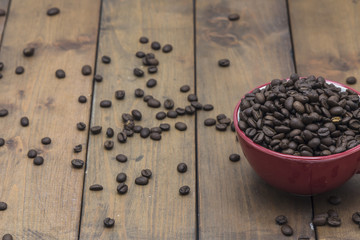coffee beans in a coffee cup on a wooden floor