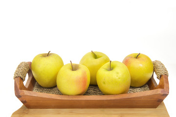 Golden apples in a basket.