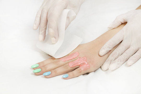 Process depilation female legs and hands in a beauty salon