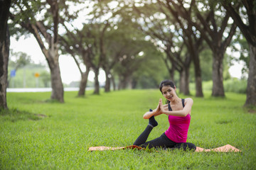 Young woman practicing yoga in park